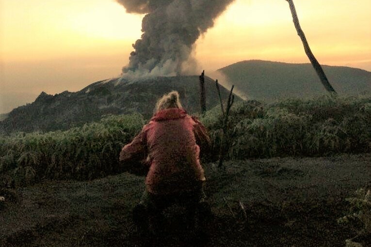 Indonesia, Halmahera: Kathrin photographing Ibu volcano eruption