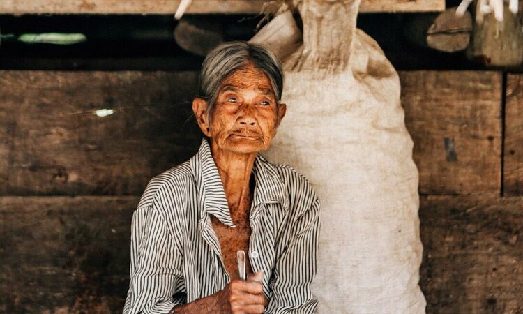 Indonesia, Little Sunda Island Sumba: Old woman in front of her house