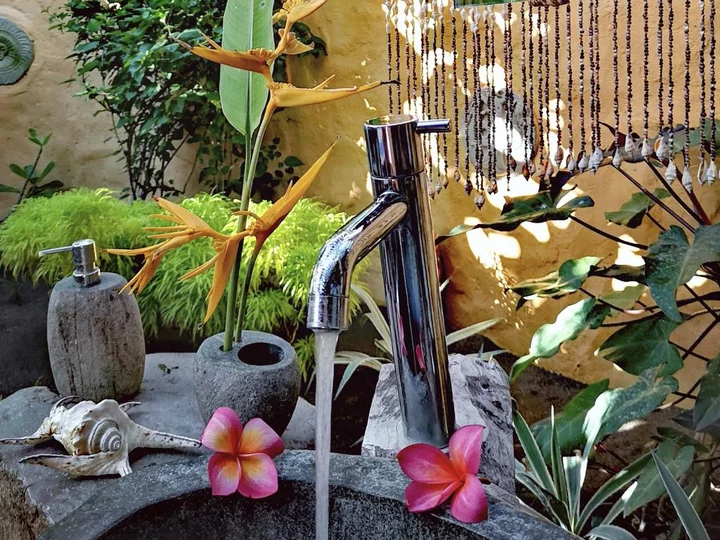 Outdoor bathroom with green plants at Coconut Garden Beach Resort, Flores Island/Lesser Sunda Islands