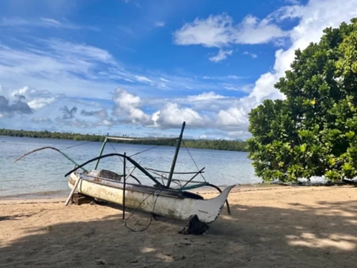 Molukken, Halmahera: Kleines weißes Holzboot am Strand