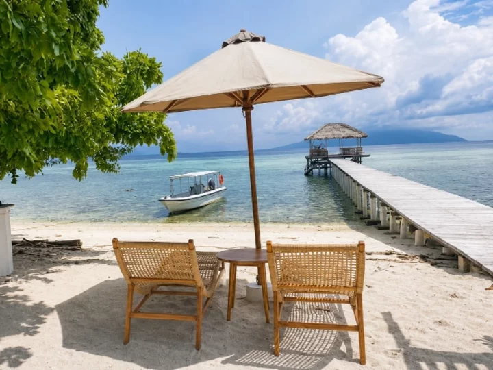 Reconnect Resort, Buka-Buka Island, Togean Marine Park: Cozy Deck Chairs with Sun Umbrella and View to Pier & Ocean