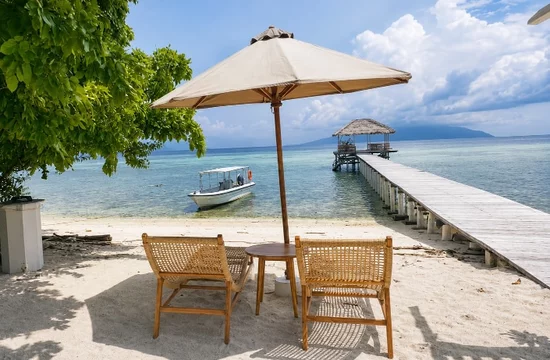 Reconnect Resort, Buka-Buka Island, Togean Marine Park: Cozy Deck Chairs with Sun Umbrella and View to Pier & Ocean