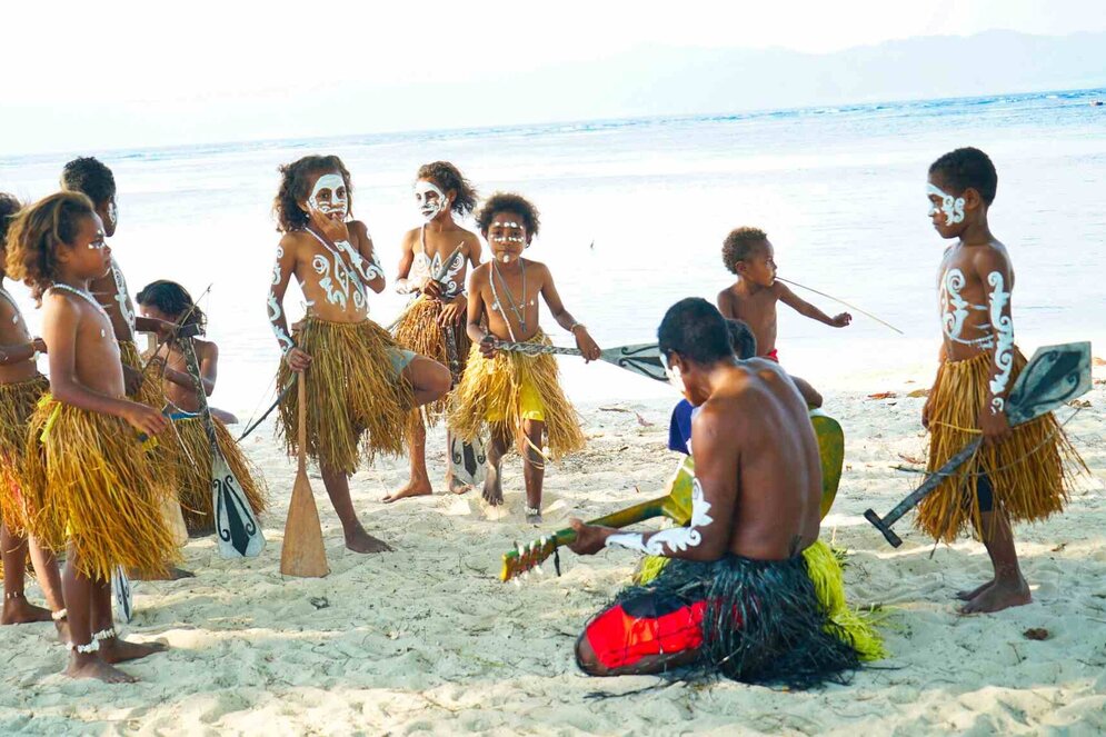 Papuan kids performing dancing in Raja Ampat