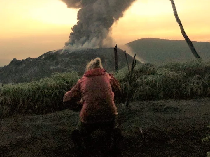 Indonesia, Halmahera: Kathrin photographing Ibu volcano eruption