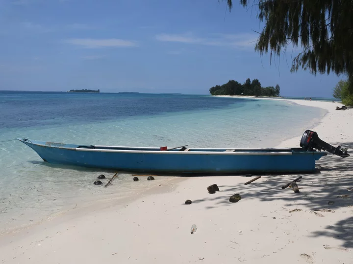 Dodola Island, Morotai: Boat on white sandy beach