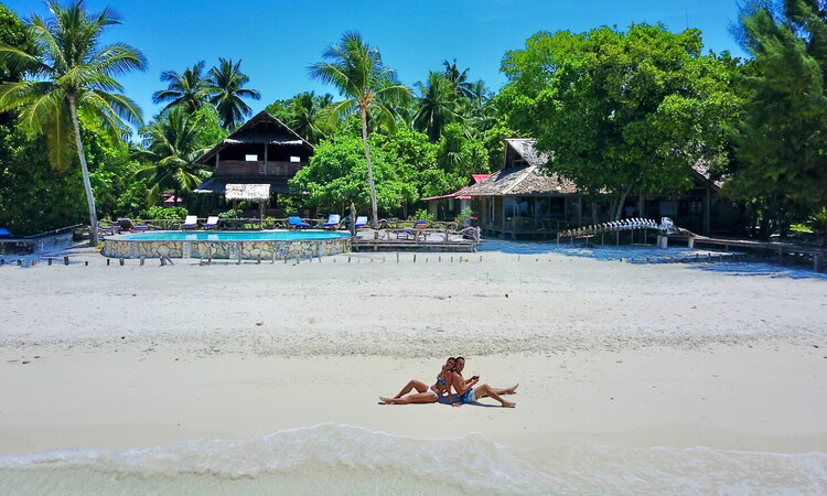  Raja Ampat Agusta Eco Resort with beach enthusiasts on white sandy beach