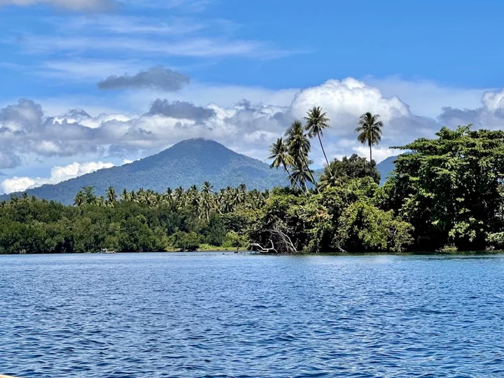 Indonesia, Moluccas: Landscape panorama Halmahera with mountain, sea & palm trees