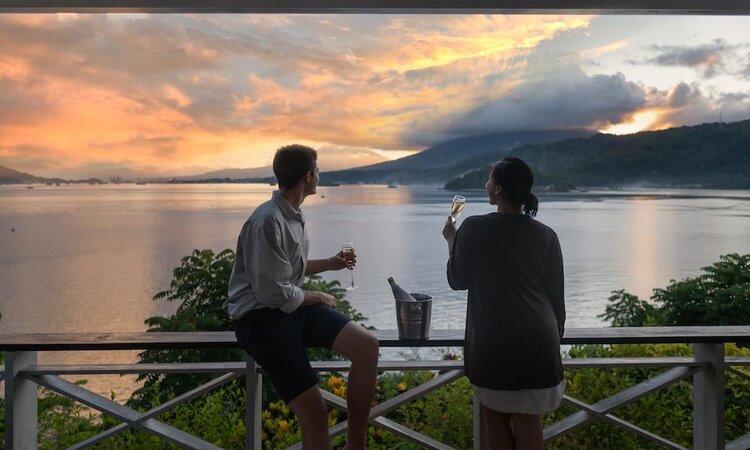  Couple enjoying the sunset from the terrace at Lembeh Resort, Lembeh Island - Sulawesi