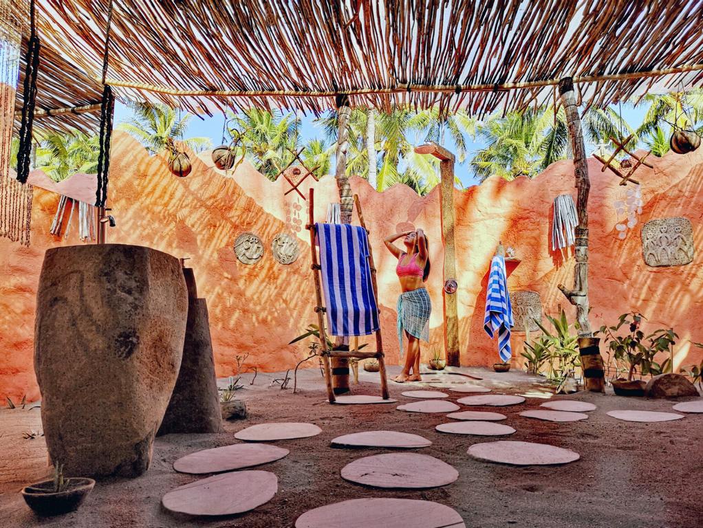Indonesien, Flores: Coconut Garden Beach Resort, Frau in Bad mit Außendusche